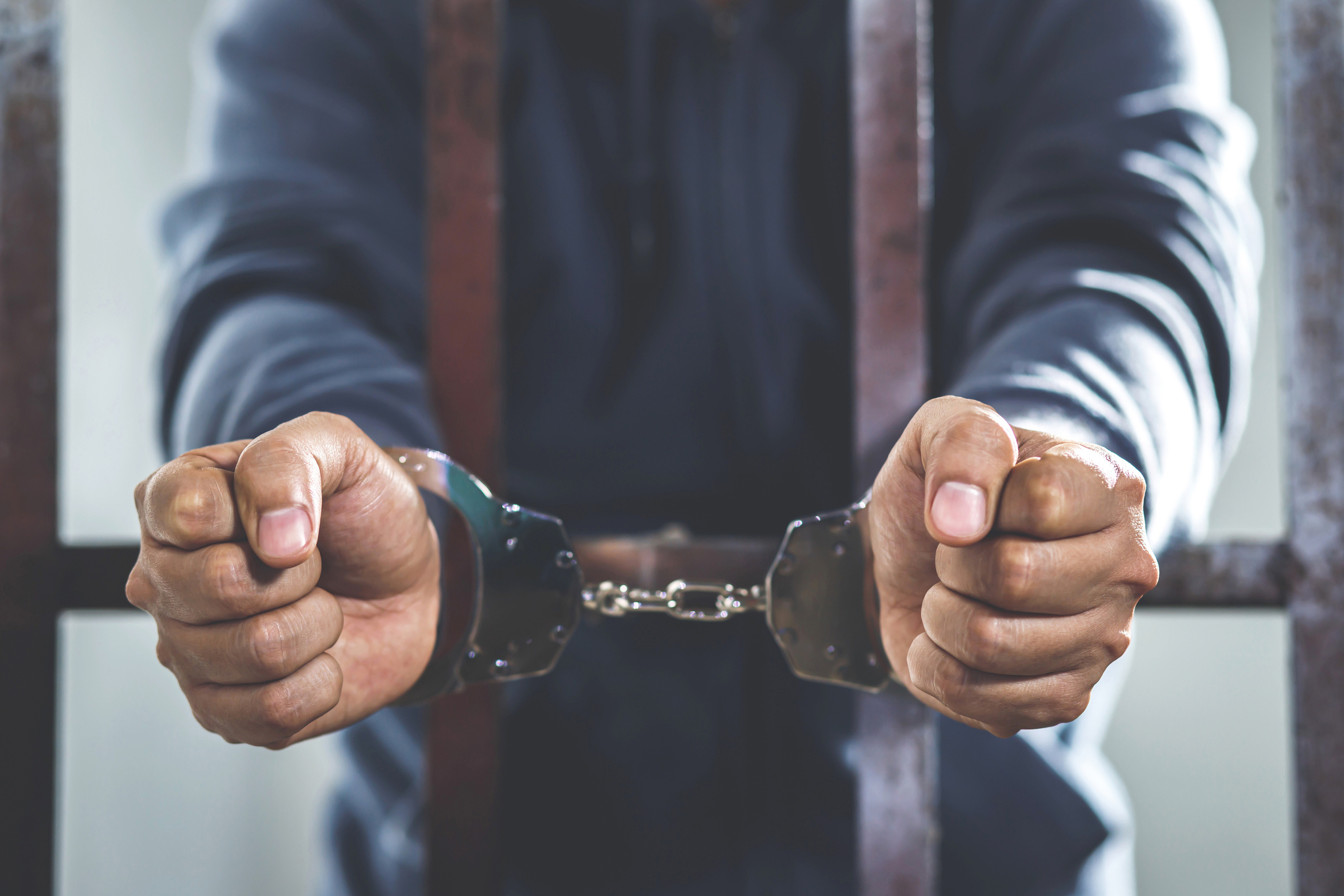 Prisoner with Handcuffs in Jail       